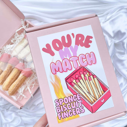 Valentine sponge biscuit fingers dipped in white chocolate, decorated like match stickers with cute packaging gift design saying ' you're my match '