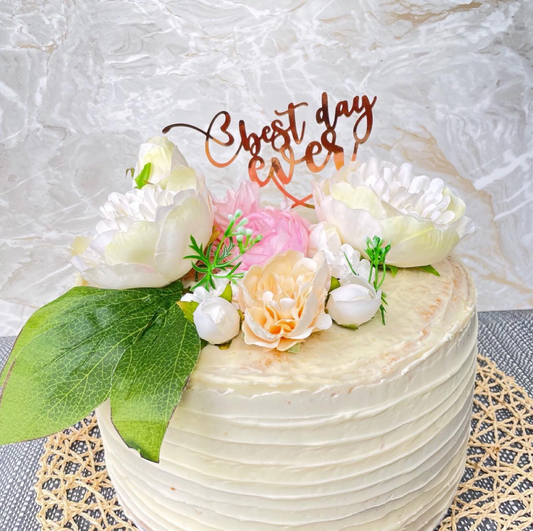 layered white cake with flowers on top